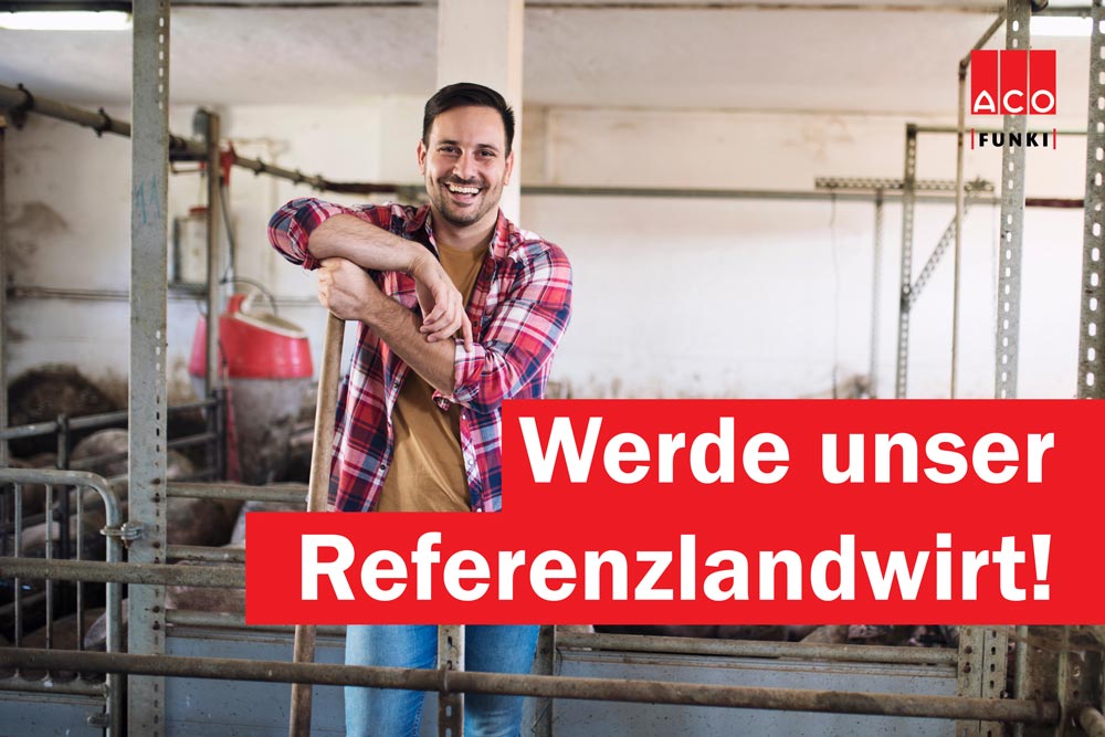 Portrait of cheerful farmer standing in cattle shed at pig farm. Food and meat production.